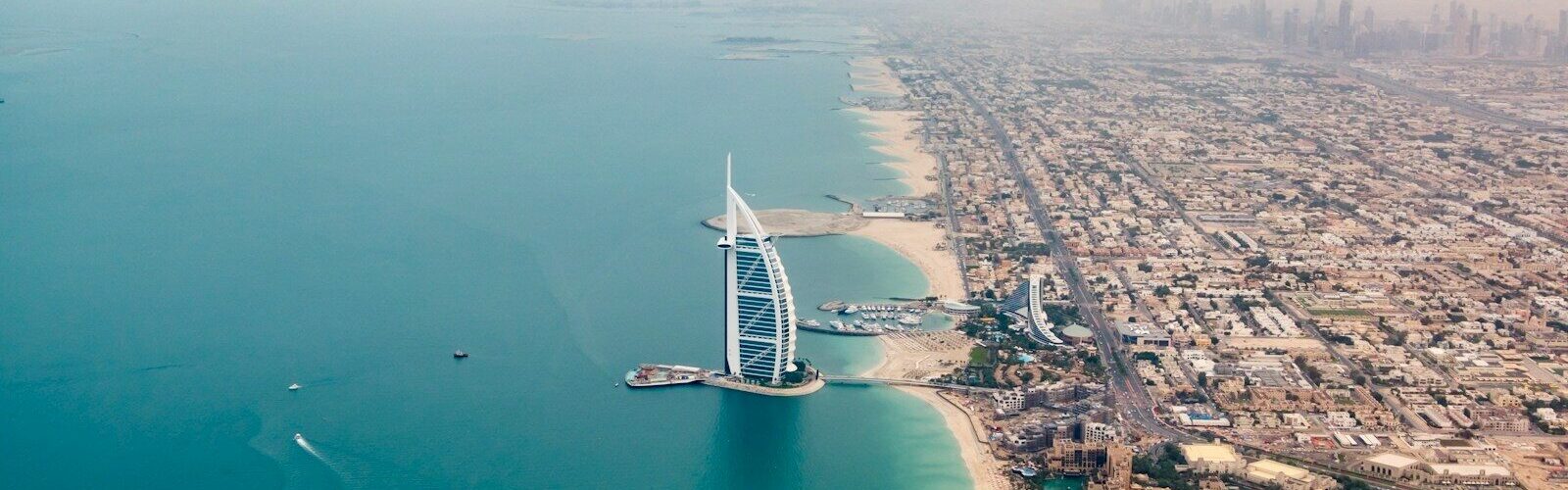 an aerial view of the burj al arab in the middle of the ocean